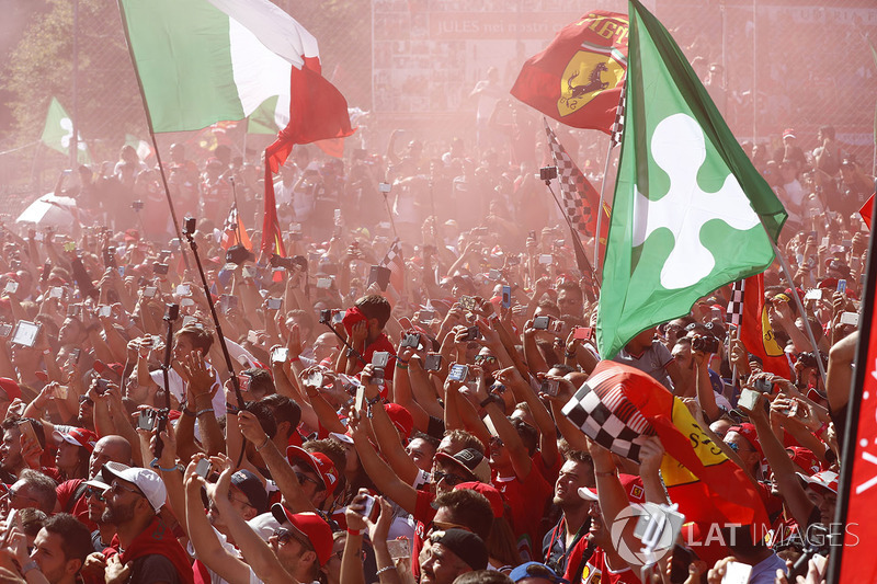 A throng of Ferrari fans invade the circuit after the race