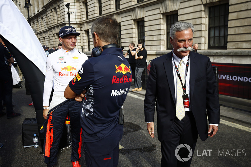 Chase Carey, Chairman, Formula One, walks past Max Verstappen, Red Bull