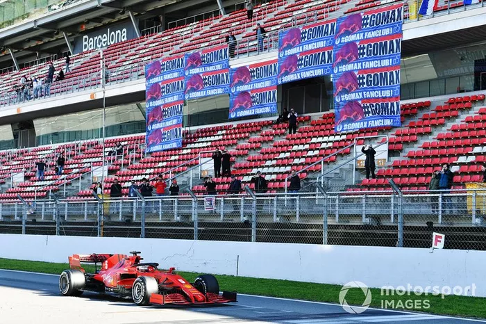 Sebastian Vettel, Ferrari SF1000, passes a stand showing banners in support of Max Verstappen, Red Bull Racing 