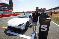 Daniel Ricciardo, Red Bull Racing, and Martin Brundle pose with a Pirelli Hot laps Aston Martin DB11