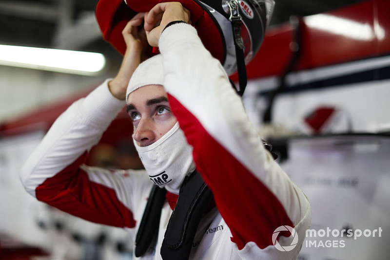 Charles Leclerc, Sauber, puts on his helmet.