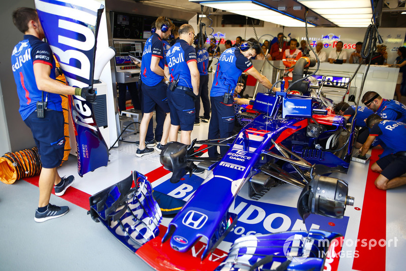 The Brendon Hartley Toro Rosso STR13 is worked on in the team's garage