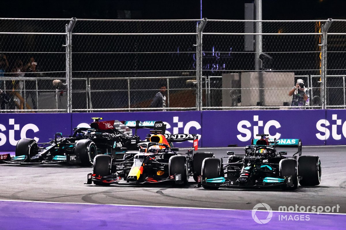 Lewis Hamilton, Mercedes W12, battles with Max Verstappen, Red Bull Racing RB16B, ahead of Valtteri Bottas, Mercedes W12