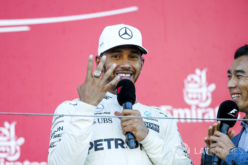 Race winner Lewis Hamilton, Mercedes AMG F1, tries on the Indy 500 winners ring belonging to interviewer Takuma Sato