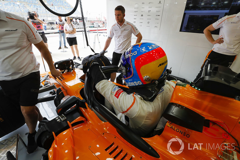 Fernando Alonso, McLaren, climbs in to his car