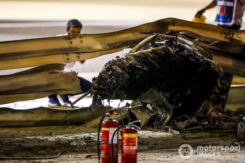 Marshals deal with the wreckage after a huge crash for Romain Grosjean, Haas VF-20, on the opening lap