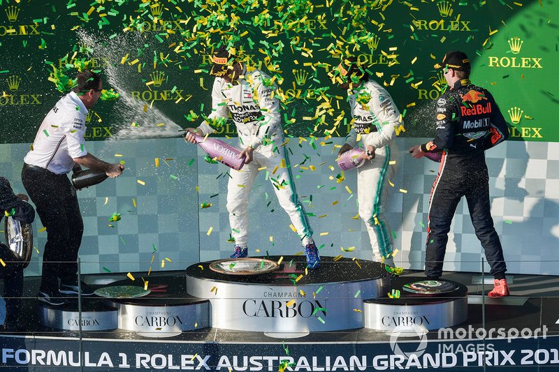 Champagne and confetti fill the air as the drivers celebrate on the podium