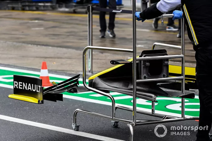 A Renault mechanic with a front wing
