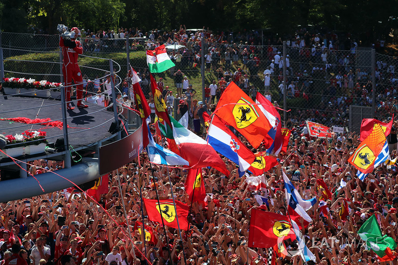 Sebastian Vettel, Ferrari celebrates on the podium, the Ferrari fans and flags