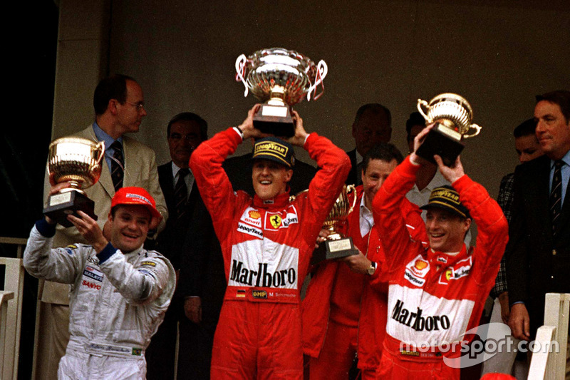 Podium: Race winner Michael Schumacher, Ferrari F310B; second place Rubens Barrichello, Stewart SF1 