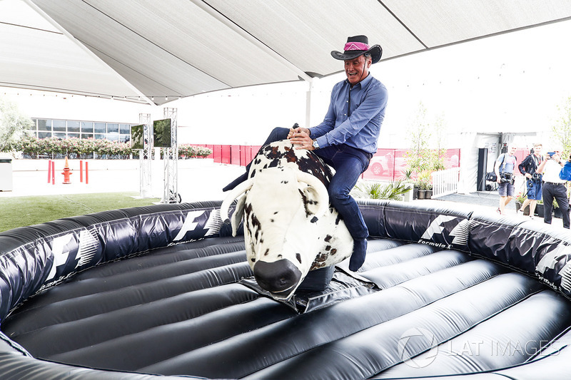 David Coulthard, Commentator, Channel 4 F1, tries his hand on a mechanical rodeo bull