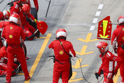 Ferrari mechanics wait for Kimi Raikkonen, Ferrari SF71H, to make a pit stop