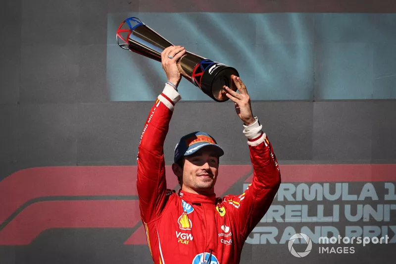 Charles Leclerc, Scuderia Ferrari, 1st position, lifts the trophy in celebration 