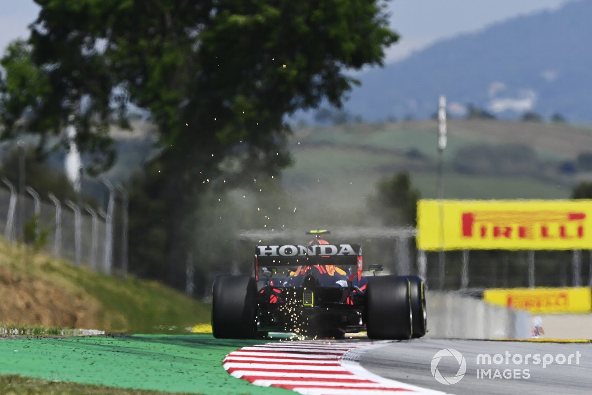 Sparks kick up from the rear of Sergio Perez, Red Bull Racing RB16B