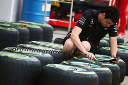 Mercedes AMG F1 Team mechanic works on Pirelli tyres