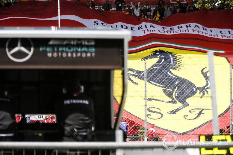 Ferrari flag in the grandstand behind the Mercedes gantry