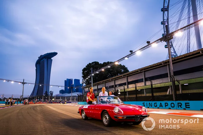 Sebastian Vettel, Ferrari, is filmed in an Alfa Romeo Spyder on the drivers' parade