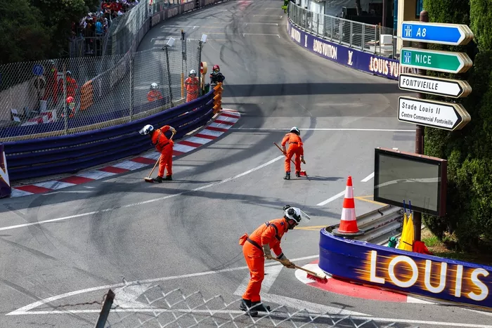 Marshals clear the track under the red flag.