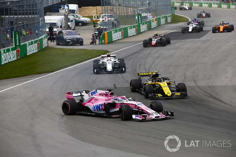 A sideways Sergio Perez, Force India VJM11, battles with Carlos Sainz Jr., Renault Sport F1 Team R.S. 18