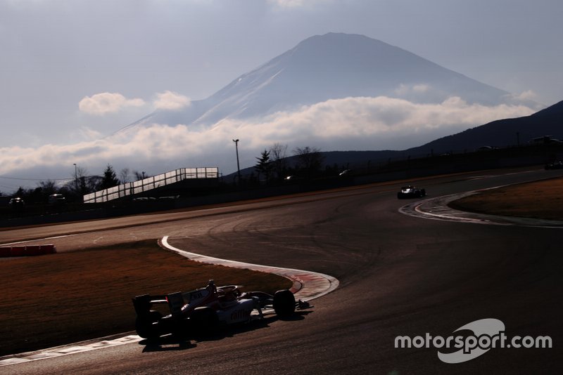 Track action with Mount Fuji in the background