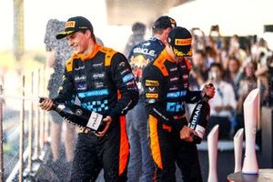 Oscar Piastri, McLaren, 3rd position, Lando Norris, McLaren, 2nd position, spray Champagne on the podium