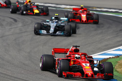 Sebastian Vettel, Ferrari SF71H, leads Valtteri Bottas, Mercedes AMG F1 W09, and Kimi Raikkonen, Ferrari SF71H