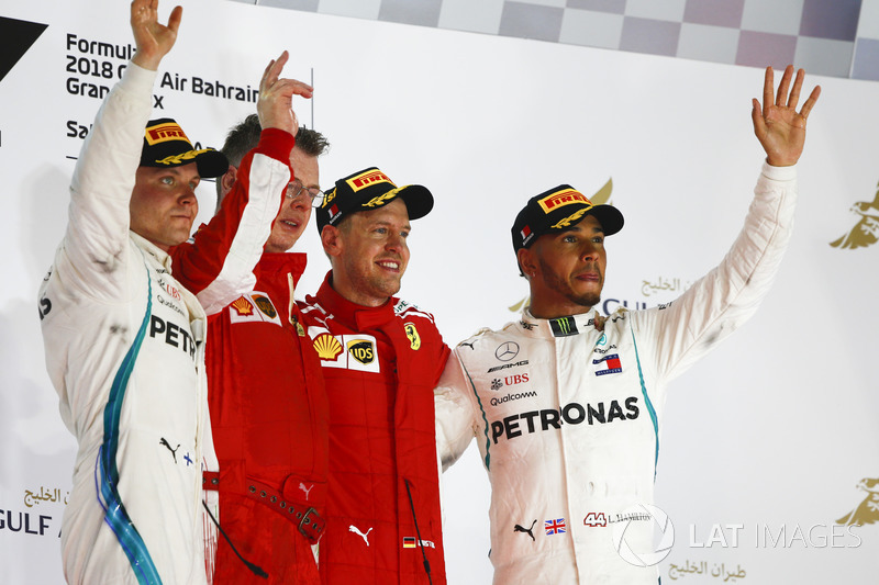 Valtteri Bottas, Mercedes AMG F1, 2nd position, Sebastian Vettel, Ferrari, 1st position, and Lewis Hamilton, Mercedes AMG F1, 3rd position, on the podium with the Ferrari Constructors trophy delegate