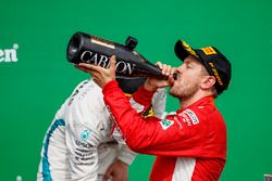 Sebastian Vettel, Ferrari, 1st position, drinks Champagne on the podium