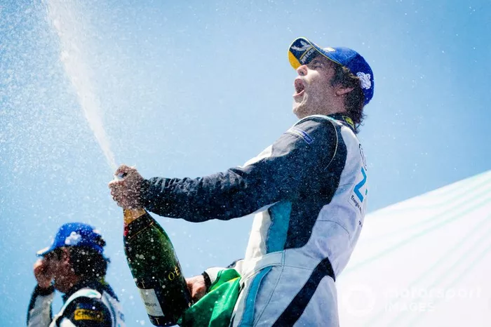 Race winner Sérgio Jimenez, Jaguar Brazil Racing celebrates with the champagne on the podium