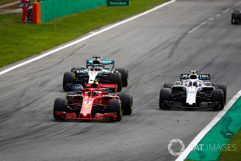 Kimi Raikkonen, Ferrari SF71H, Lewis Hamilton, Mercedes AMG F1 W09, as they put a lap on Sergey Sirotkin, Williams FW41