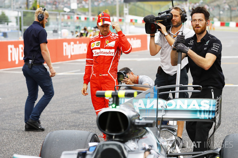 Sebastian Vettel, Ferrari, looks at the Mercedes AMG F1 W08 of Lewis Hamilton, Mercedes AMG F1