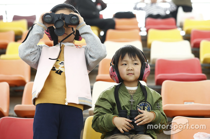 Young fans watch the activity with Binoculars