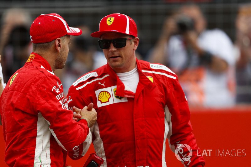Kimi Raikkonen, Ferrari, congratulates team mate Sebastian Vettel, Ferrari