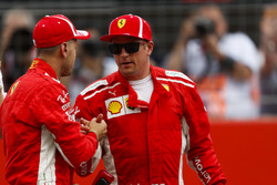 Kimi Raikkonen, Ferrari, congratulates team mate Sebastian Vettel, Ferrari