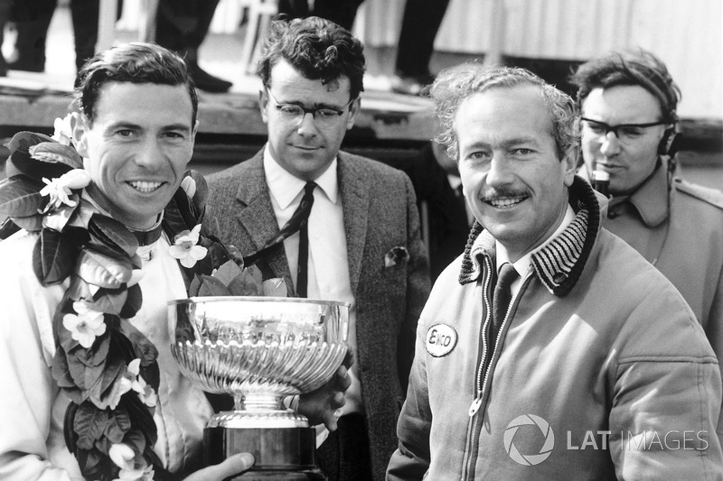 Race winner Jim Clark, Lotus, receives the winners trophy with team boss, Colin Chapman on the podiu