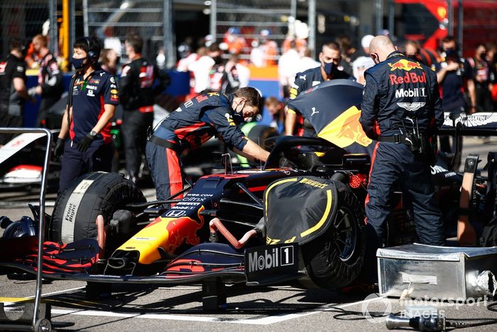 Los mecánicos trabajan en el auto de Alex Albon, Red Bull Racing RB16, en la parrilla