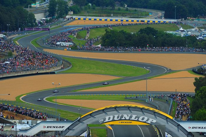 General view of the Dunlop Bridges and the esses as a trio of Peugeot 908 race cars leads the field