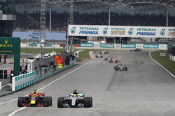 Lewis Hamilton, Mercedes AMG F1 W08, battles, Max Verstappen, Red Bull Racing RB13, for the lead