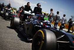 Jenson Button, McLaren MP4-31 is pushed onto the grid by team members ahead of Fernando Alonso, McLaren MP4-31