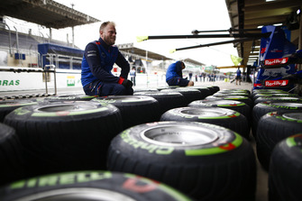 A Toro Rosso mechanic works on Pirelli tyres