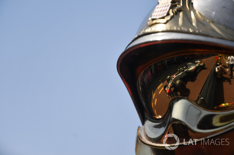 Romain Grosjean, Haas F1 Team VF-18 reflected in a fireman helmet