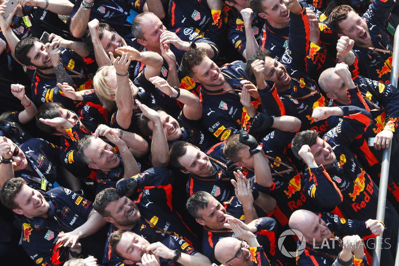 The Red Bull team celebrate victory at the podium