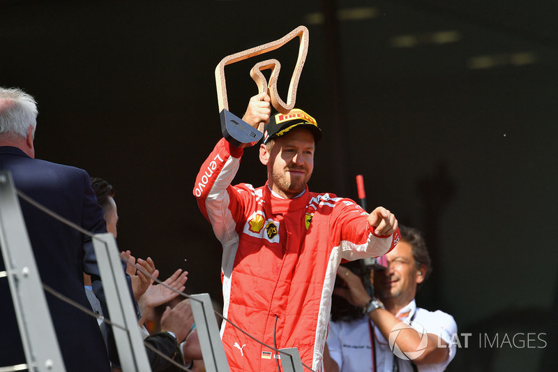 Sebastian Vettel, Ferrari celebrates on the podium with the trophy