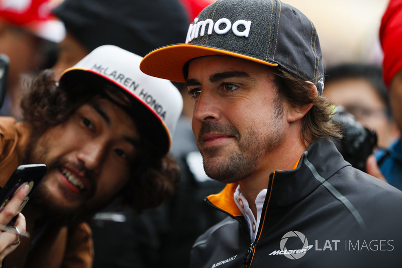 Fernando Alonso, McLaren, signs autographs for fans