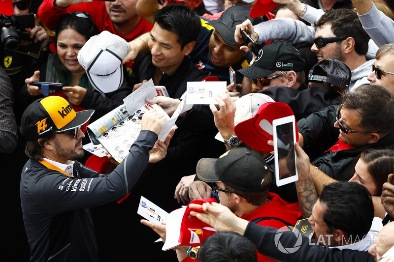 Fernando Alonso, McLaren, signs autographs for fans