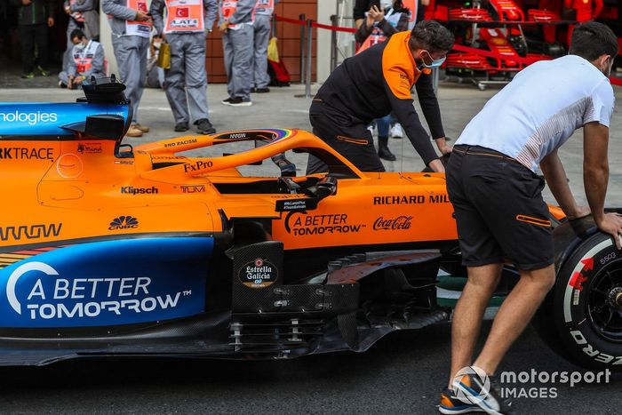Mecánicos de McLaren llevan el coche por el pitlane de Turquía