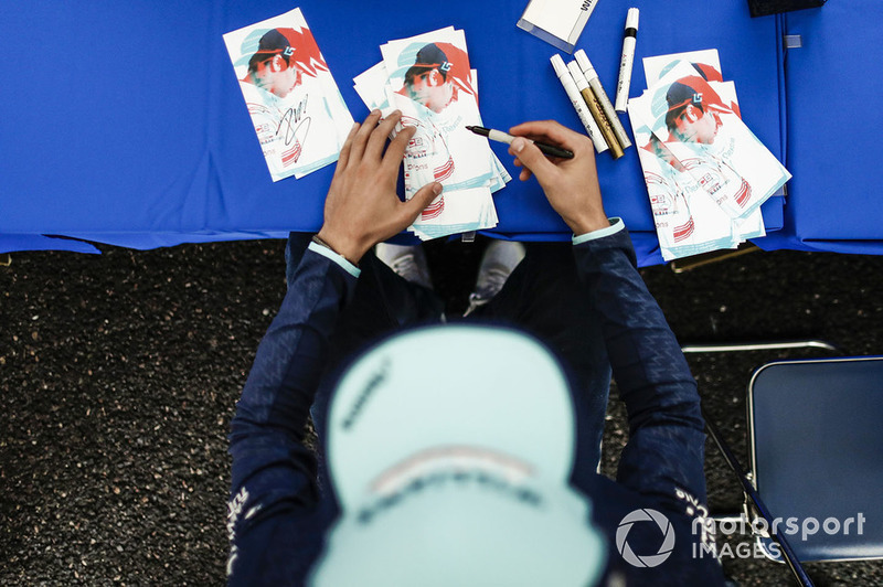 Lance Stroll, Williams Racing, signs an autograph for a fan