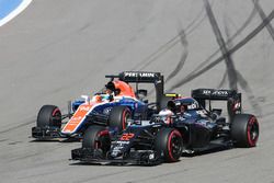 Jenson Button, McLaren MP4-31 and Rio Haryanto, Manor Racing MRT05 battle for position