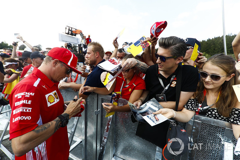 Kimi Raikkonen, Ferrari, signs autographs for fans