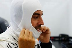 Fernando Alonso, McLaren, adjusts his balaclava before qualifying